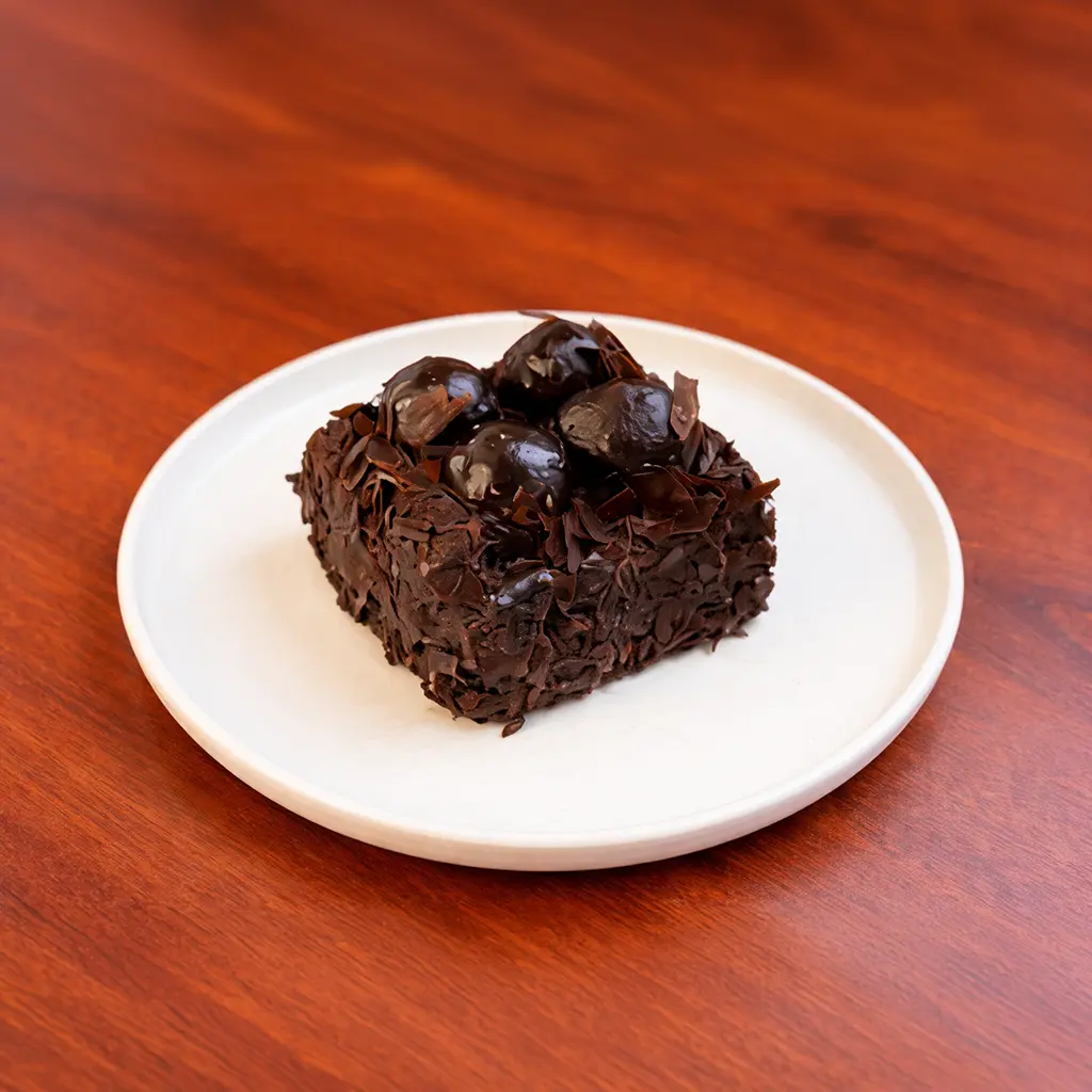 Chocolate profiterole cake slice covered in dark chocolate shavings and topped with glazed chocolate profiteroles at Cafe Galata Guelph