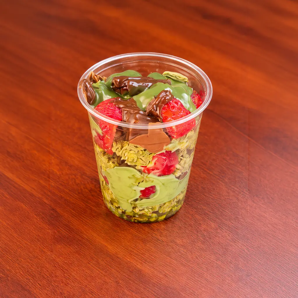 Dubai-style strawberry dessert cup layered with pistachio kataifi, fresh strawberries, chocolate drizzle and pistachio cream at Cafe Galata Guelph