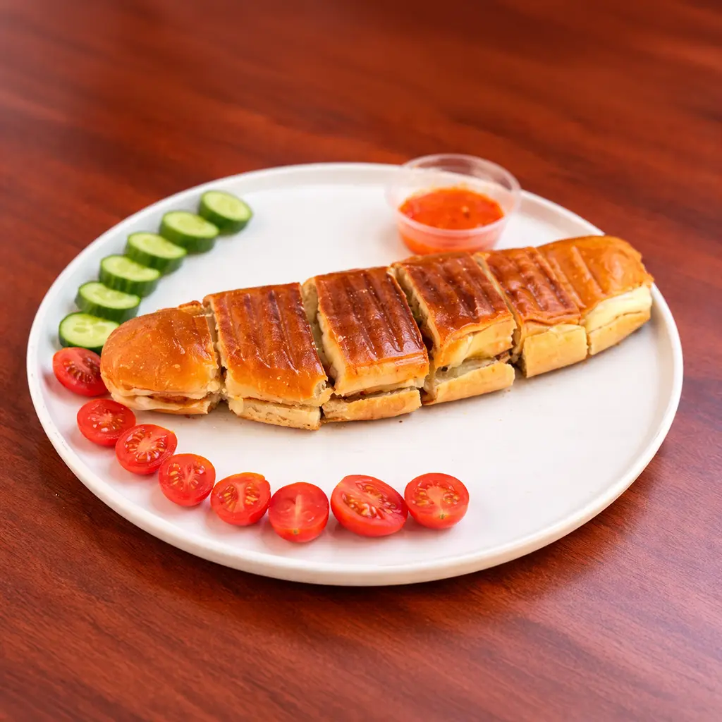 Grilled panini sandwich cut into pieces served with cherry tomatoes, sliced cucumber and red pepper dipping sauce at Cafe Galata Guelph