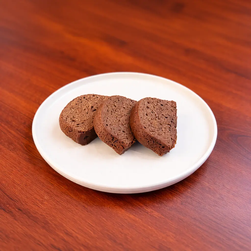 Three sliced mini chocolate cake pieces with a dense fudgy texture served on a white plate at Cafe Galata Guelph